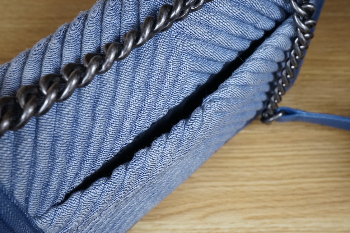 A Chanel denim cheveron flap shoulder bag with silver hardware, date code 20845697, 28cm wide